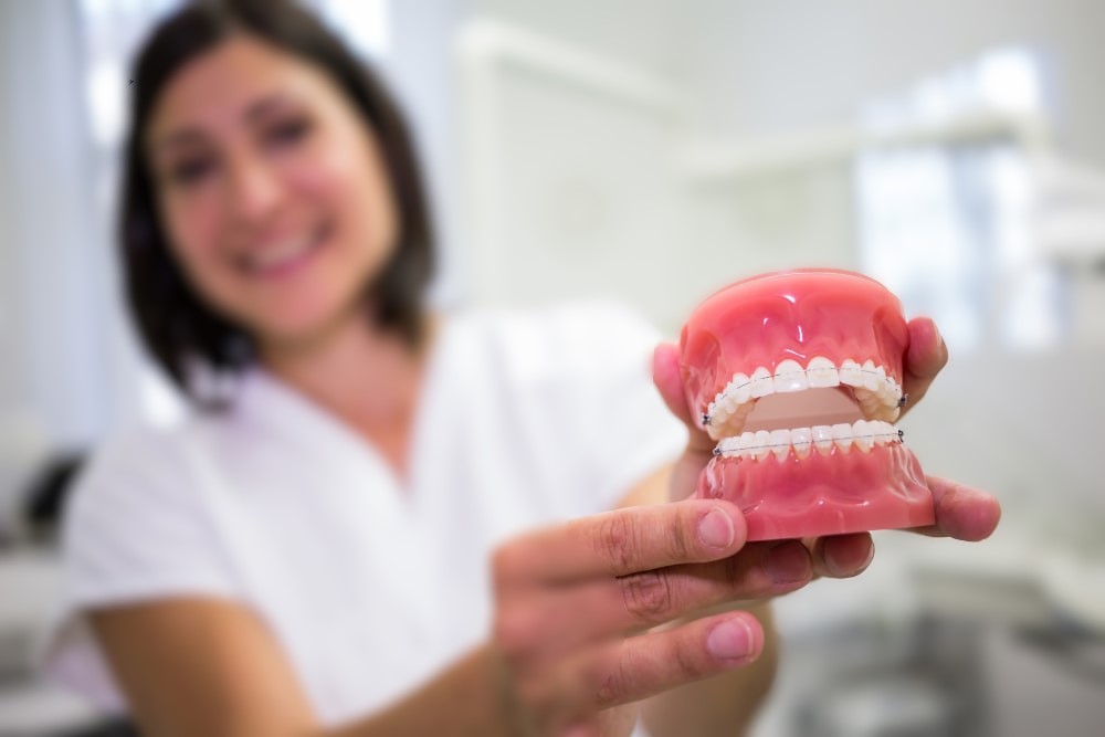 https://vitaldentalclinic.com/wp-content/uploads/2025/10/portrait-female-dentist-holding-set-dentures-2-min.jpg